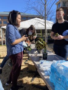 plant swap at GMB lawn with diverse groups holding plants