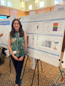 June Arricastres standing a research poster