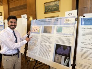 Kareem standing by his research poster at UNC