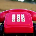 Red rotary phone with wheels