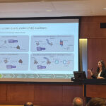 Selinl Altinok gives thesis defense talk in front of slide of CHIPs role in protein quality control (PQC) machinery.