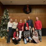 Admin staff group photo by Christmas tree